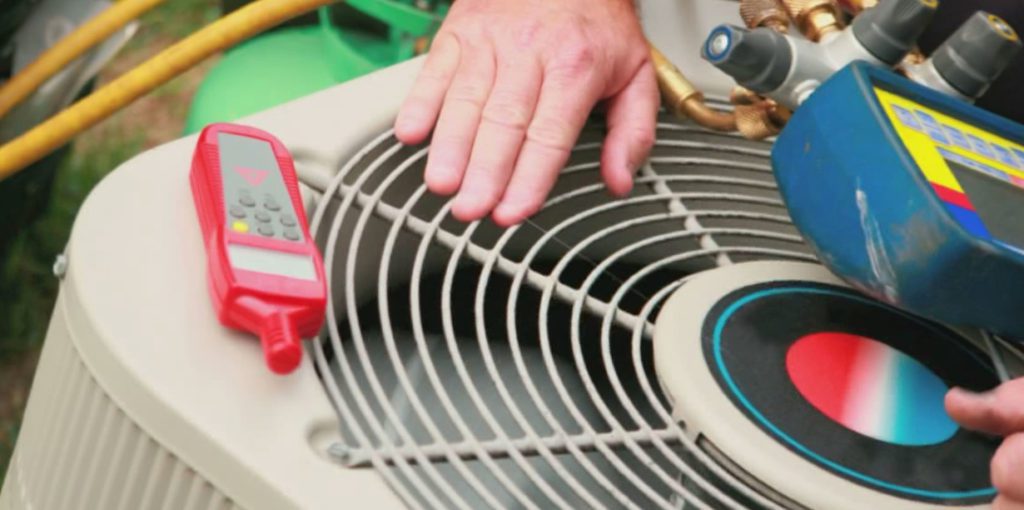 A person is working on an air conditioner.